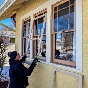 Person installing new windows on a house.