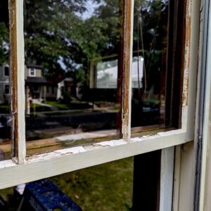 Close-up of weathered window frame needing repair.