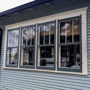 Gray house with large multi-pane windows
