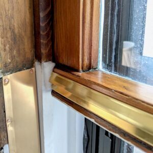 Close-up of weathered wooden window frame and sill.