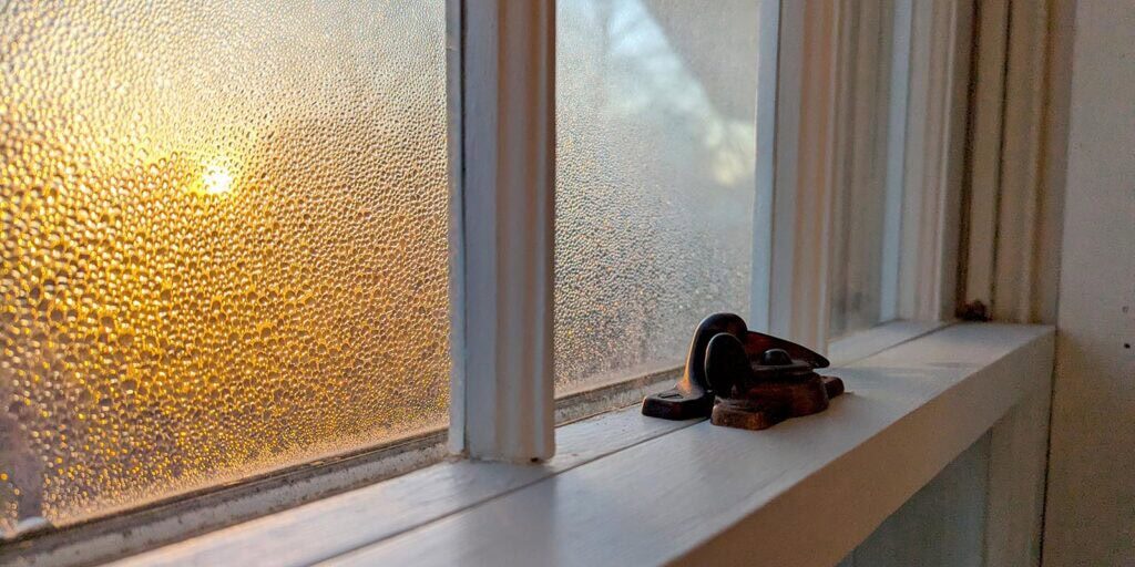 Sunrise through textured glass window with lock